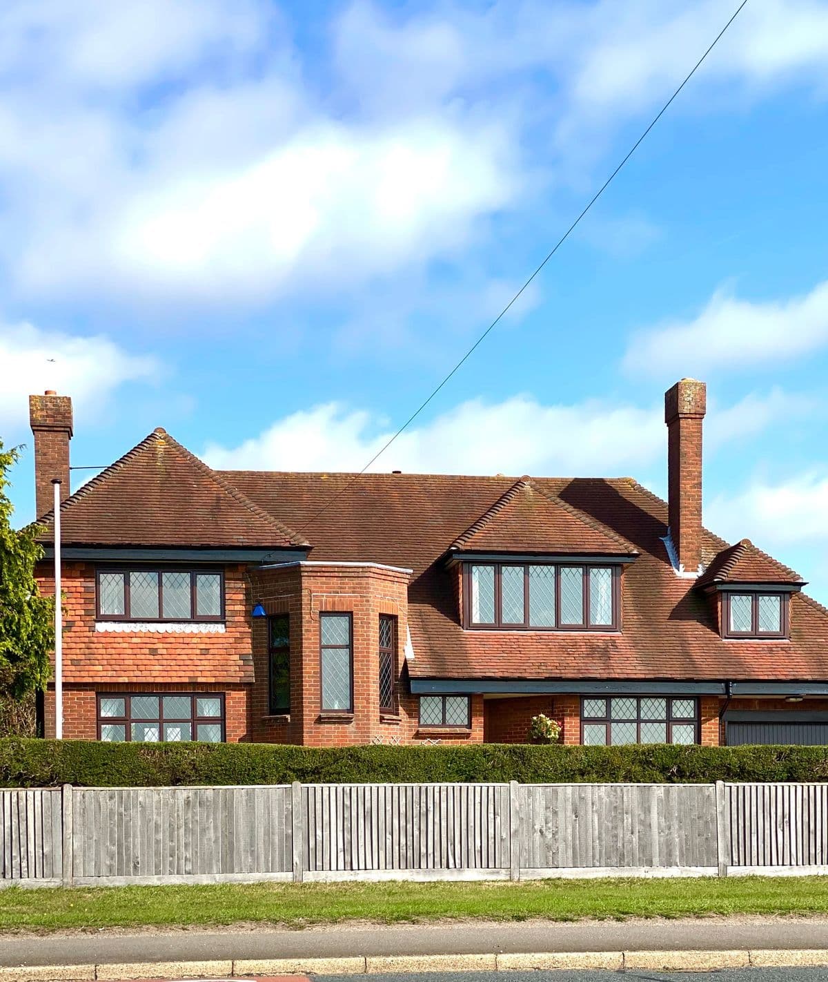 A red brick house with a garden